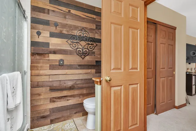 a bathroom with a toilet and a shower curtain