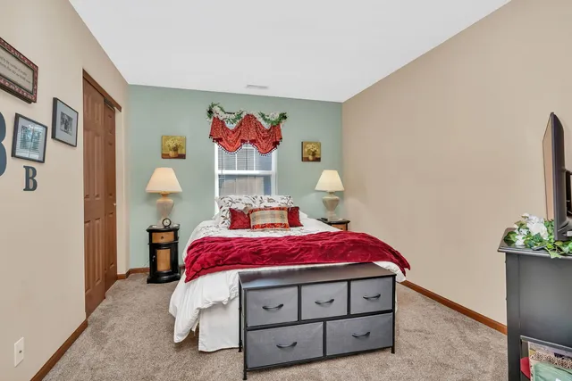 a bedroom with a bed and a potted plant
