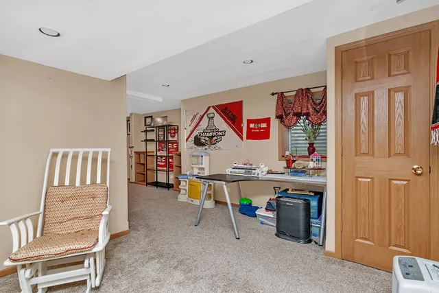 a room with lots of wooden furniture and paintings on the wall