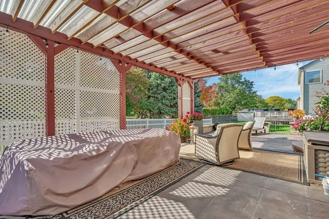 a view of a patio with a table and chairs