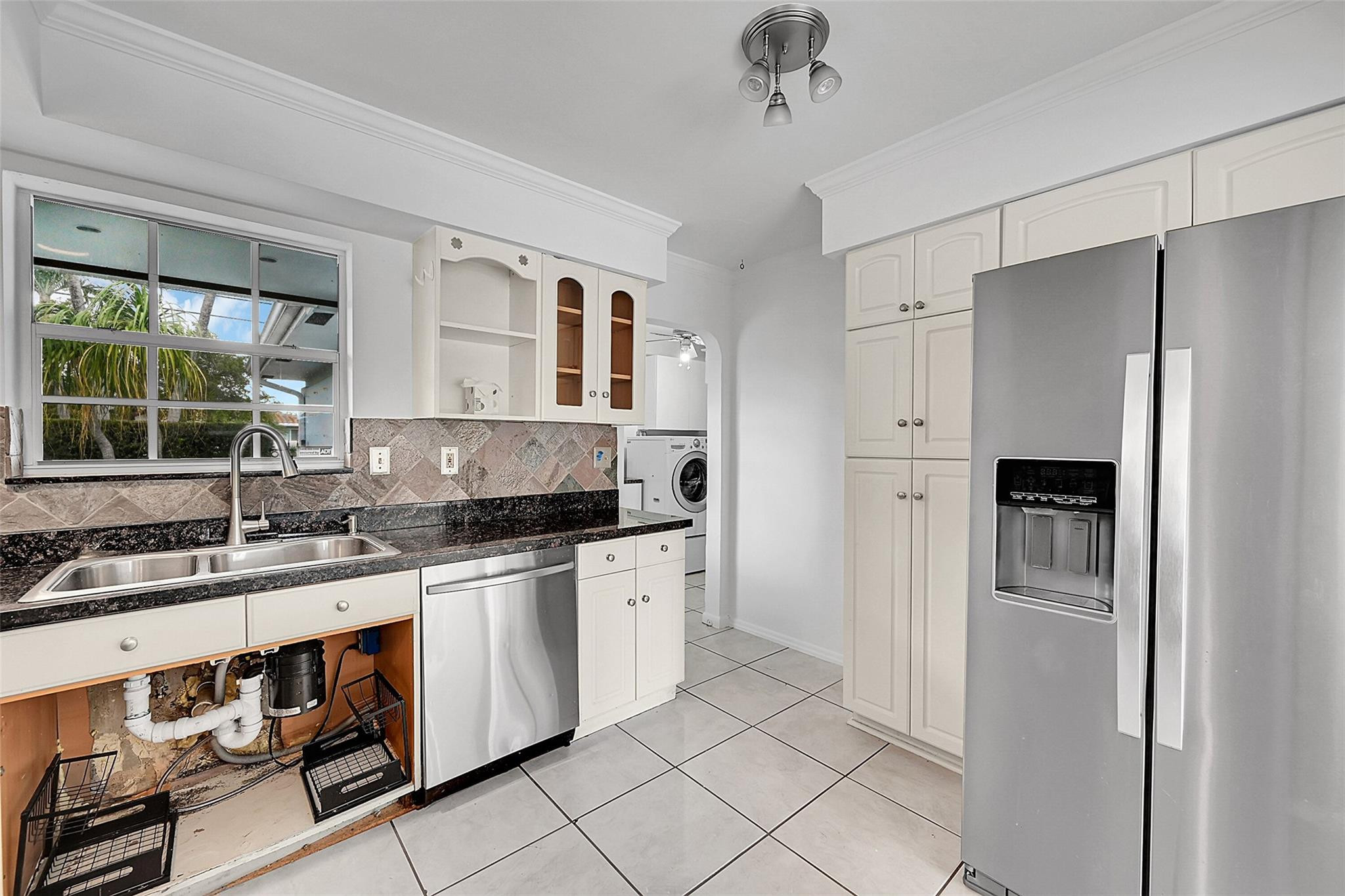 220 Southeast 10th Street Pompano Beach, FL 33060 - Photo 13 of 42 a kitchen with stainless steel appliances granite countertop a sink stove and refrigerator