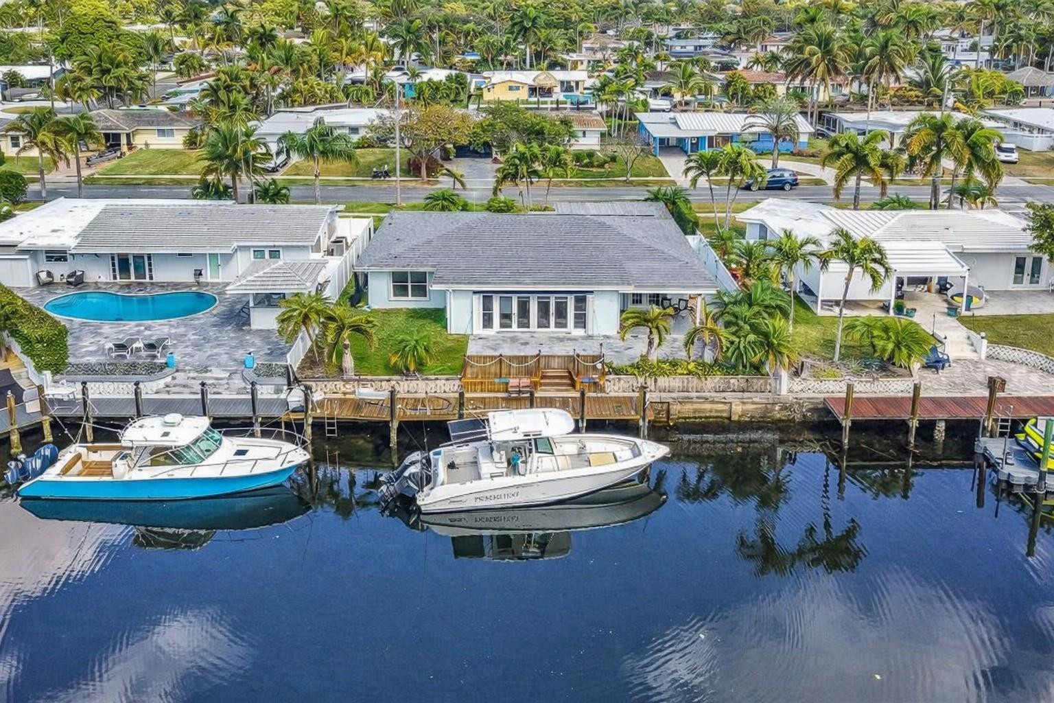 220 Southeast 10th Street Pompano Beach, FL 33060 - Photo 2 of 42 an aerial view of a house with a garden and patio