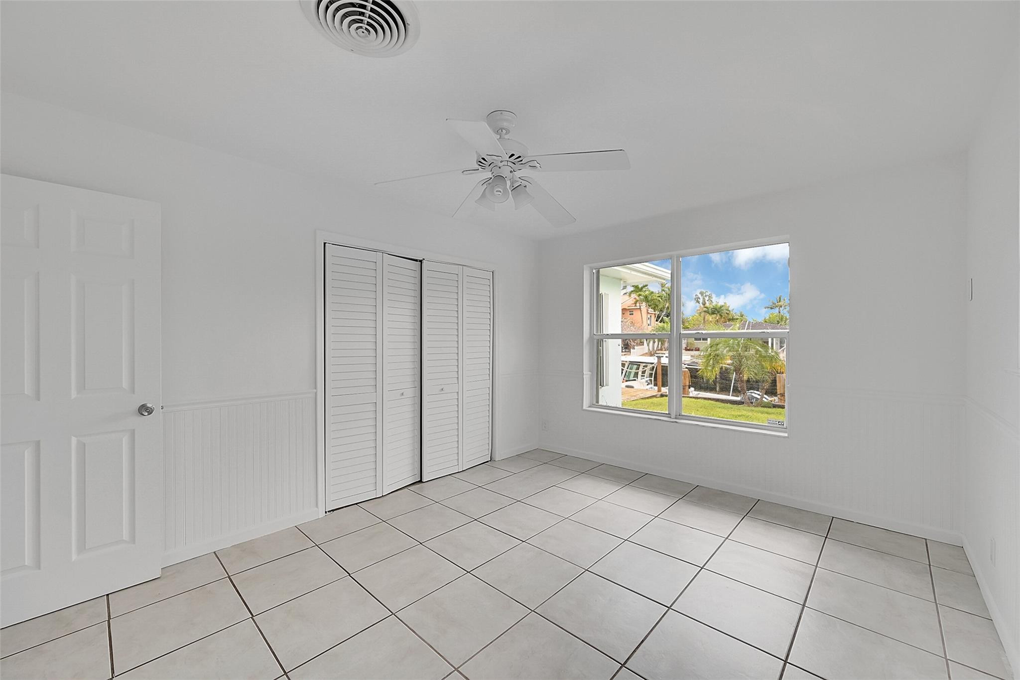 220 Southeast 10th Street Pompano Beach, FL 33060 - Photo 22 of 42 an empty room with windows and fan