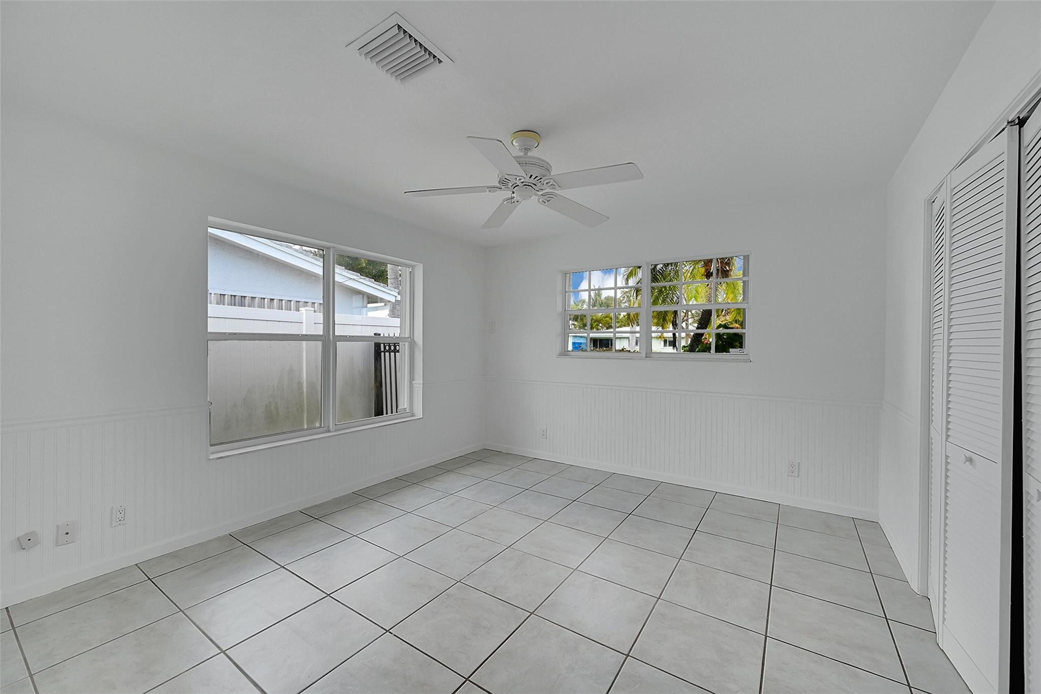 220 Southeast 10th Street Pompano Beach, FL 33060 - Photo 24 of 42 an empty room with windows and ceiling fan
