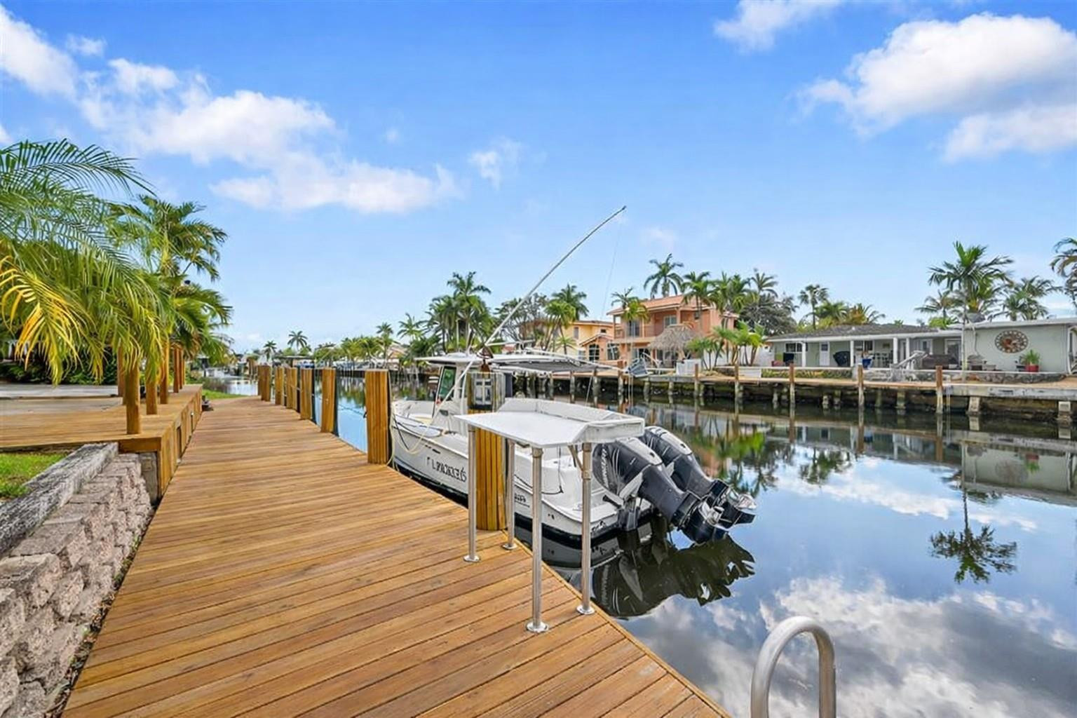 220 Southeast 10th Street Pompano Beach, FL 33060 - Photo 30 of 42 a view of a lake with boats and trees in the background