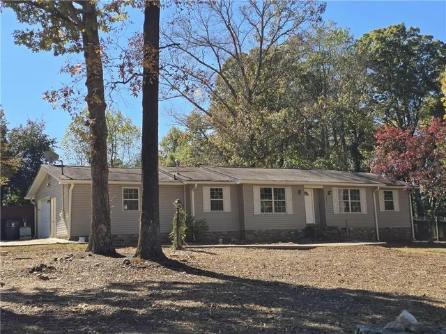 a view of a house with snow on the road