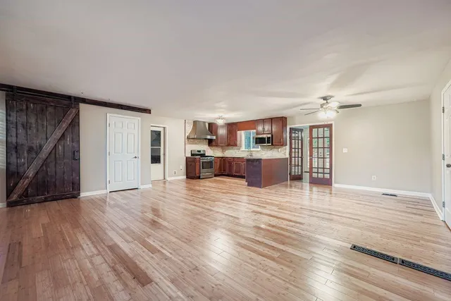 a view of a room with wooden floor and windows