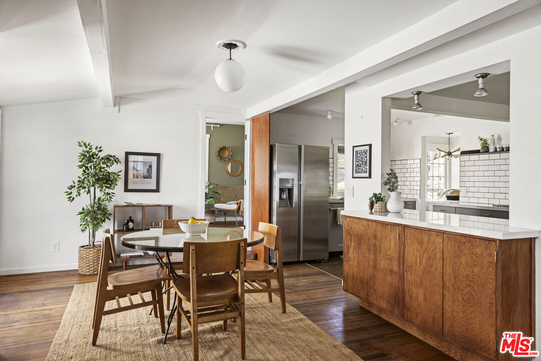10536 Pinewood Avenue Tujunga, CA 91042 - Photo 11 of 33 a view of a dining room with furniture and wooden floor