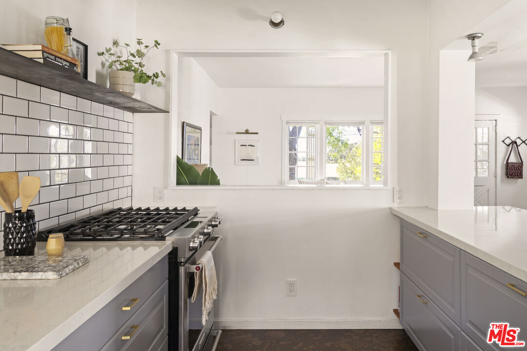 10536 Pinewood Avenue Tujunga, CA 91042 - Photo 15 of 33 a kitchen that has a sink and a stove