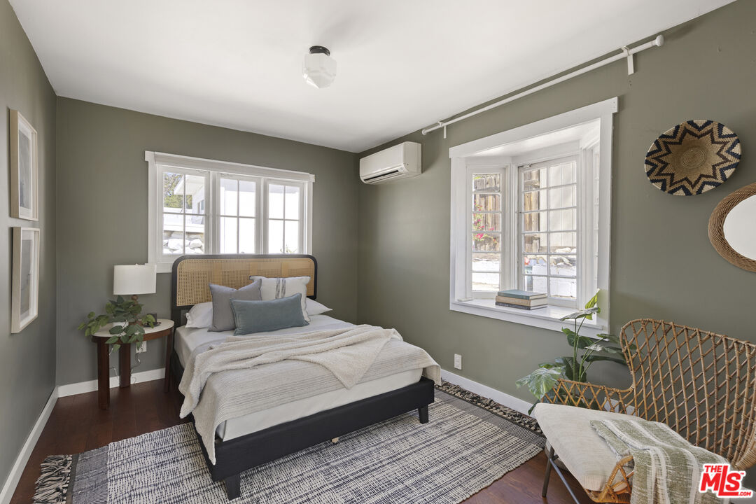 10536 Pinewood Avenue Tujunga, CA 91042 - Photo 20 of 33 a bedroom with a bed and wooden floor