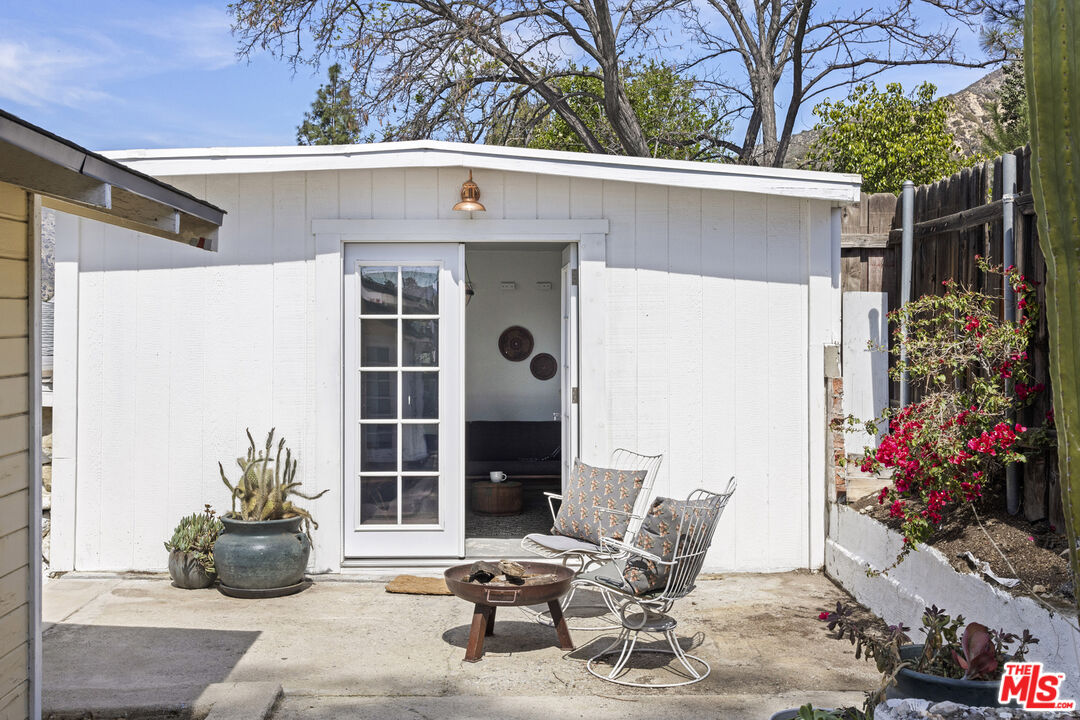 10536 Pinewood Avenue Tujunga, CA 91042 - Photo 25 of 33 a view of a chairs and table in backyard of the house