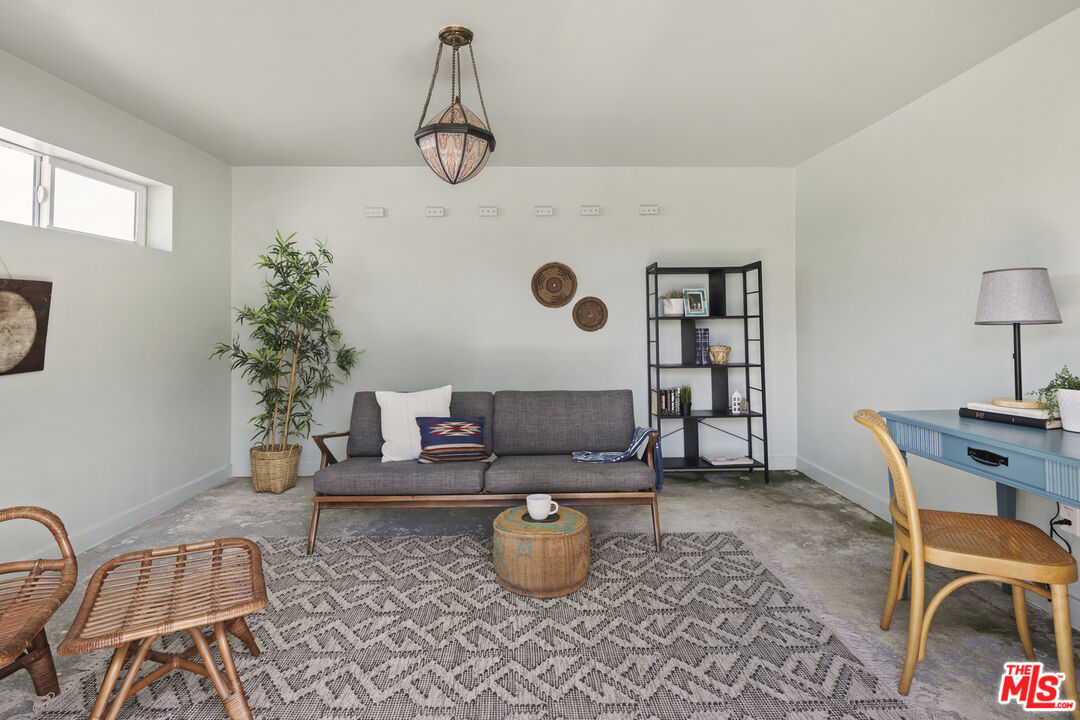 10536 Pinewood Avenue Tujunga, CA 91042 - Photo 26 of 33 a living room with furniture and a window
