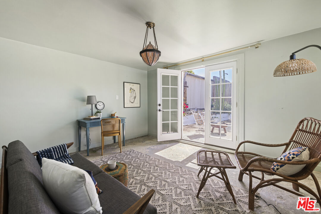 10536 Pinewood Avenue Tujunga, CA 91042 - Photo 27 of 33 a living room with furniture a window and a chandelier