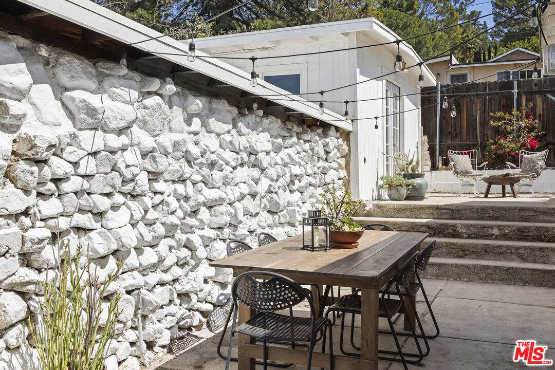 10536 Pinewood Avenue Tujunga, CA 91042 - Photo 29 of 33 a dining room with a wooden table and chairs