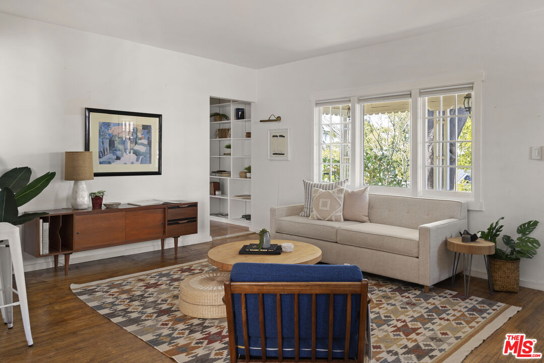 10536 Pinewood Avenue Tujunga, CA 91042 - Photo 5 of 33 a living room with furniture a rug and a window