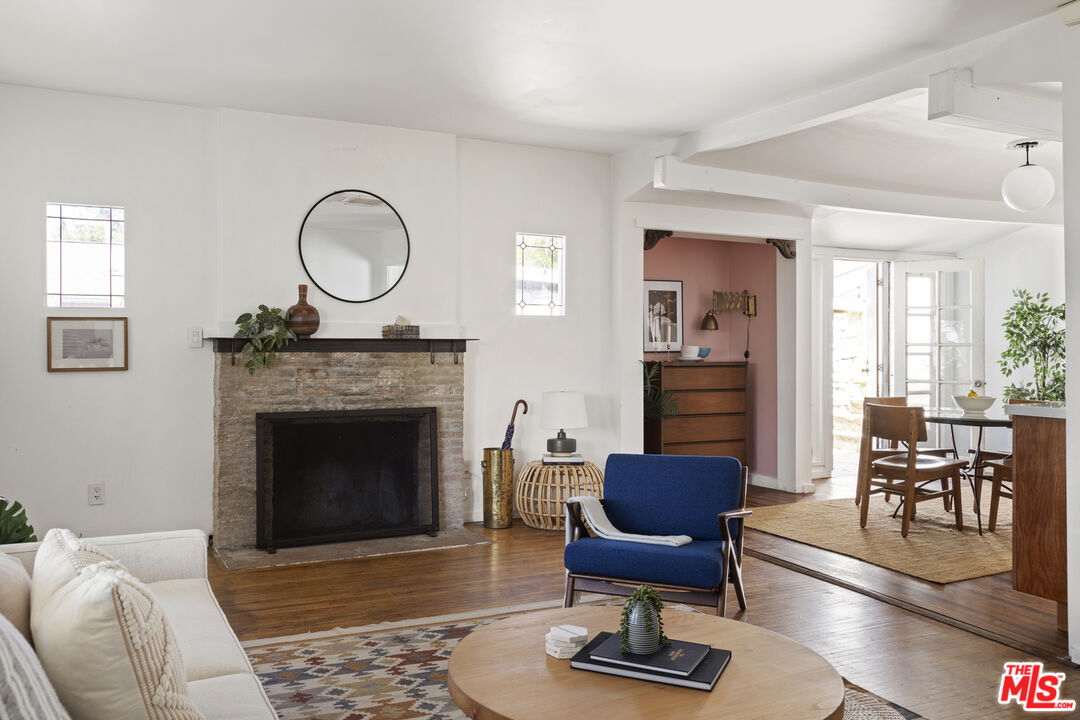 10536 Pinewood Avenue Tujunga, CA 91042 - Photo 8 of 33 a living room with furniture and a fireplace