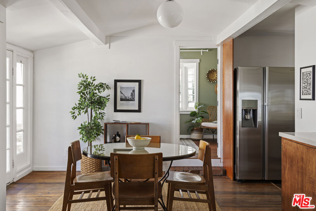10536 Pinewood Avenue Tujunga, CA 91042 - Photo 9 of 33 a dining room with furniture potted plants and wooden floor