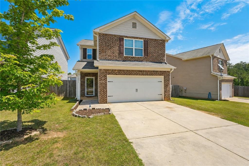 10933 Wheeler Trace Hampton, GA 30228 - Photo 1 of 22 a front view of a house with a yard