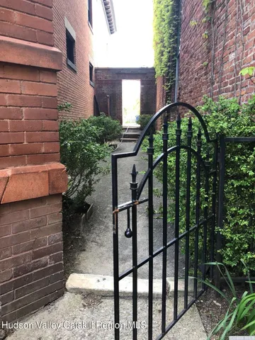 a backyard of a house with table and chairs