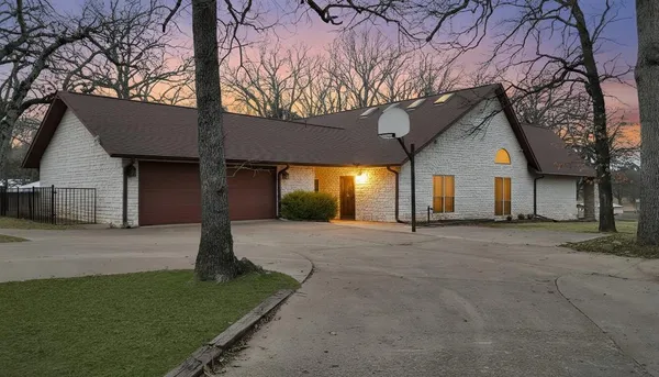 a big house with palm trees in the background