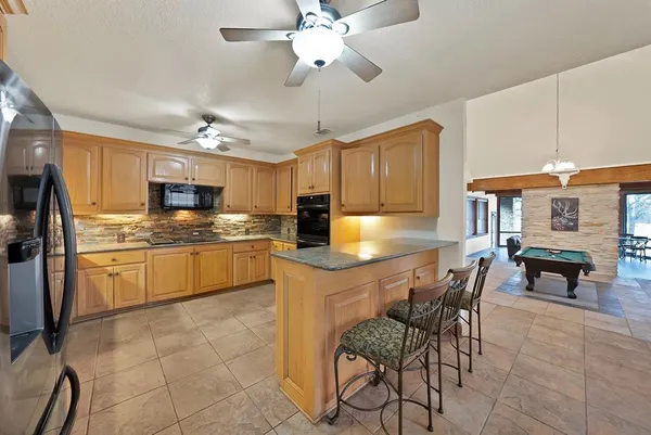 a kitchen with cabinets a sink and appliances