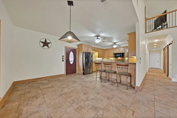 a view of a livingroom with furniture and a kitchen