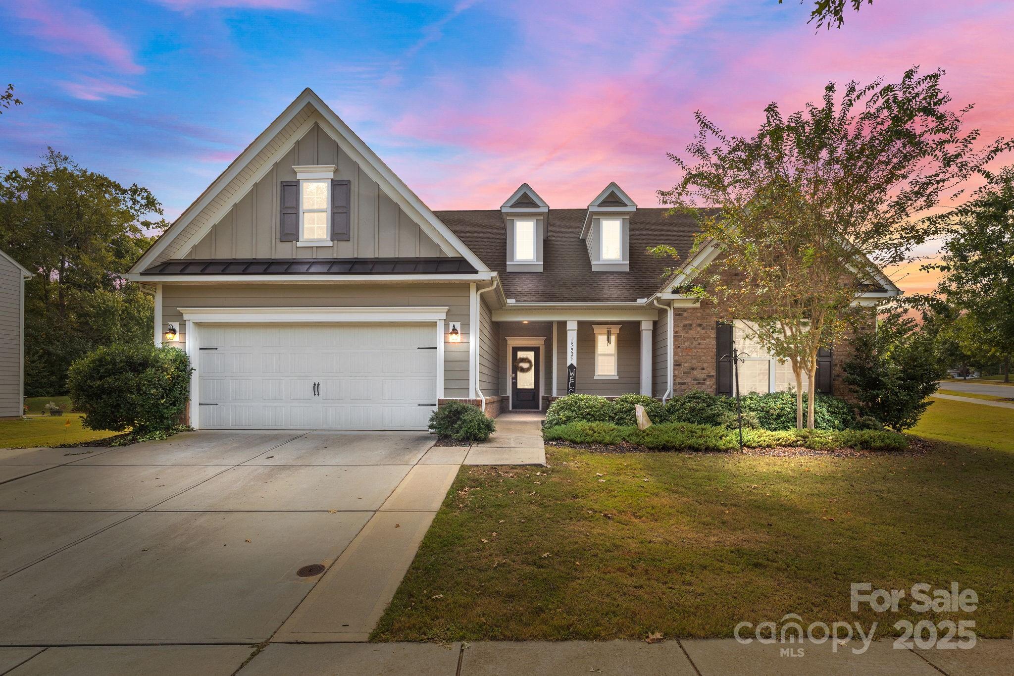 a front view of a house with a yard and garage