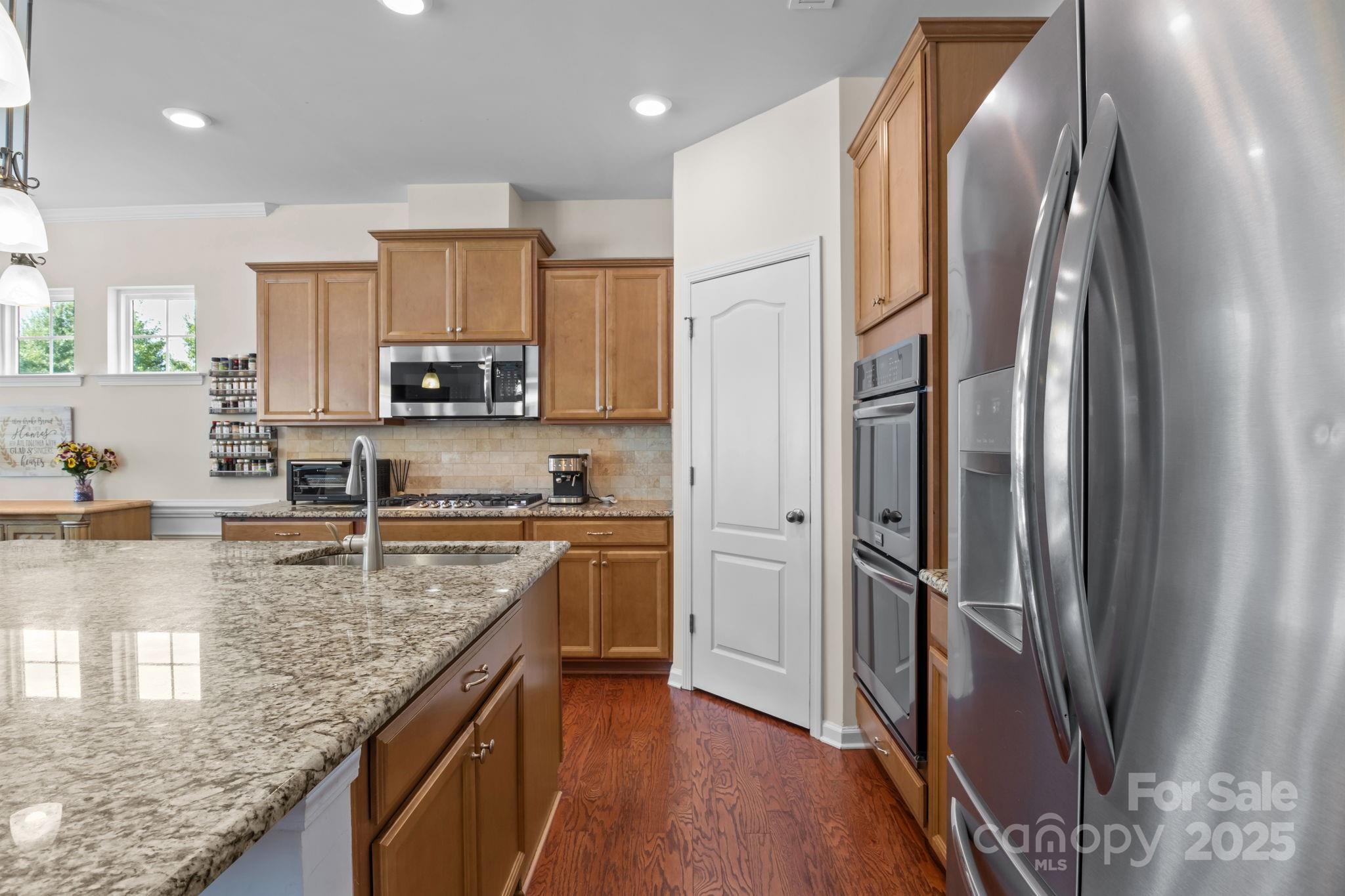 15925 Foreleigh Road Huntersville, NC 28078 - Photo 13 of 48 a kitchen with stainless steel appliances granite countertop a refrigerator a stove and a sink