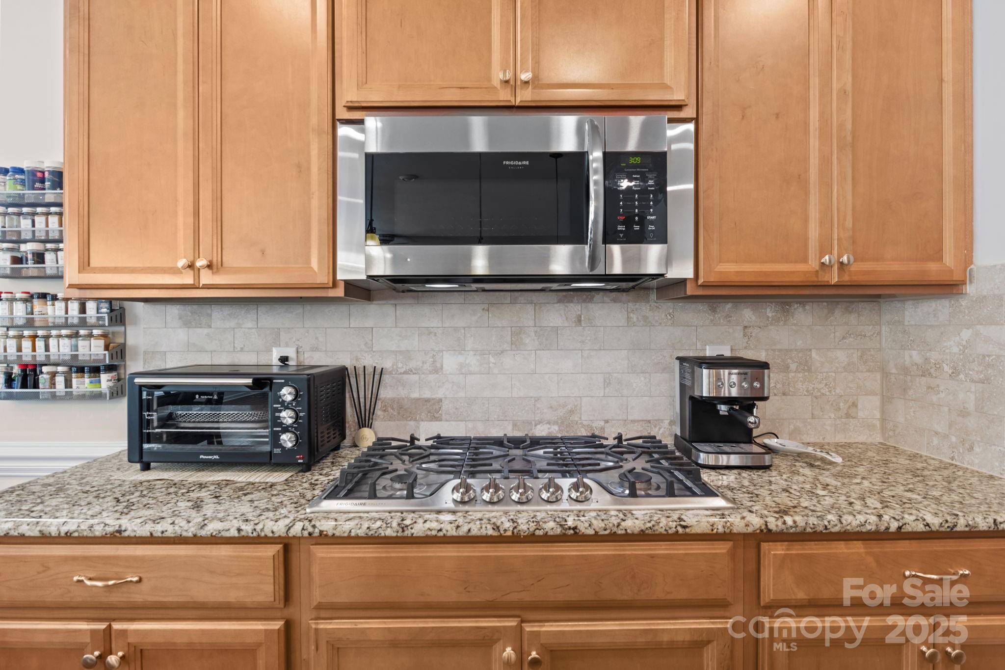 15925 Foreleigh Road Huntersville, NC 28078 - Photo 16 of 48 a kitchen with granite countertop a stove and a microwave