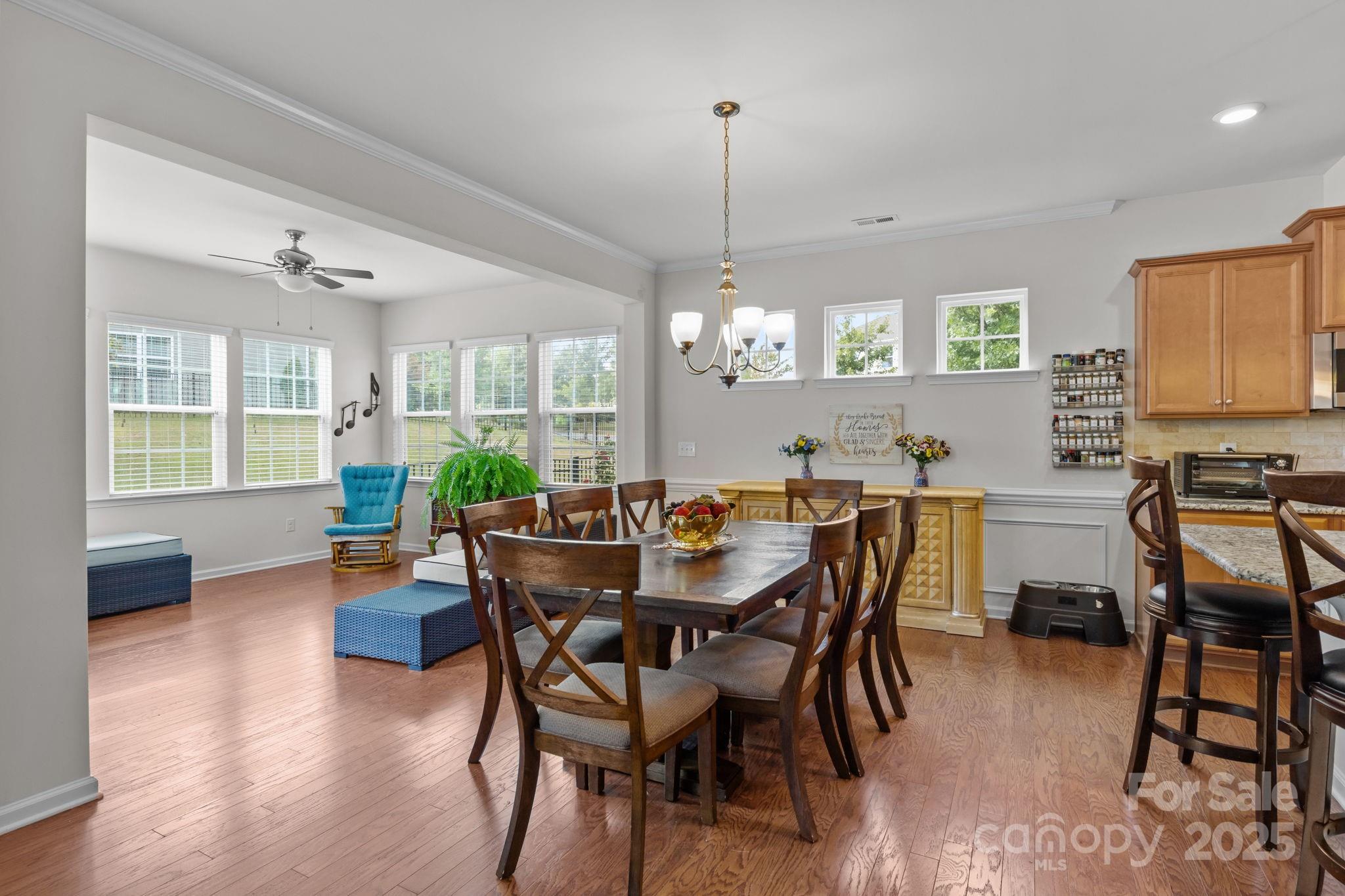 15925 Foreleigh Road Huntersville, NC 28078 - Photo 18 of 48 a view of a dining room and livingroom with furniture wooden floor a chandelier