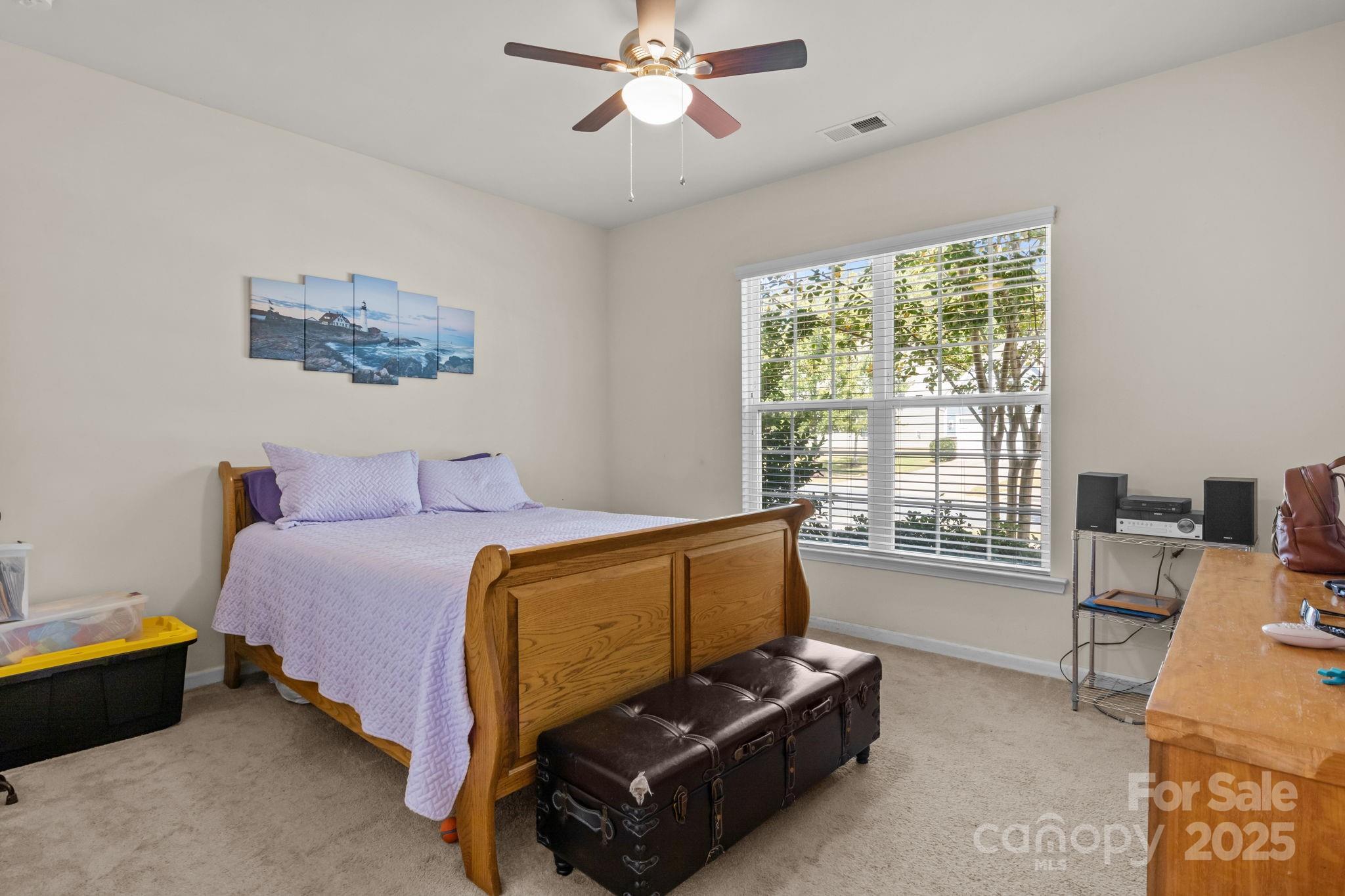 15925 Foreleigh Road Huntersville, NC 28078 - Photo 24 of 48 a spacious bedroom with a bed and a chandelier