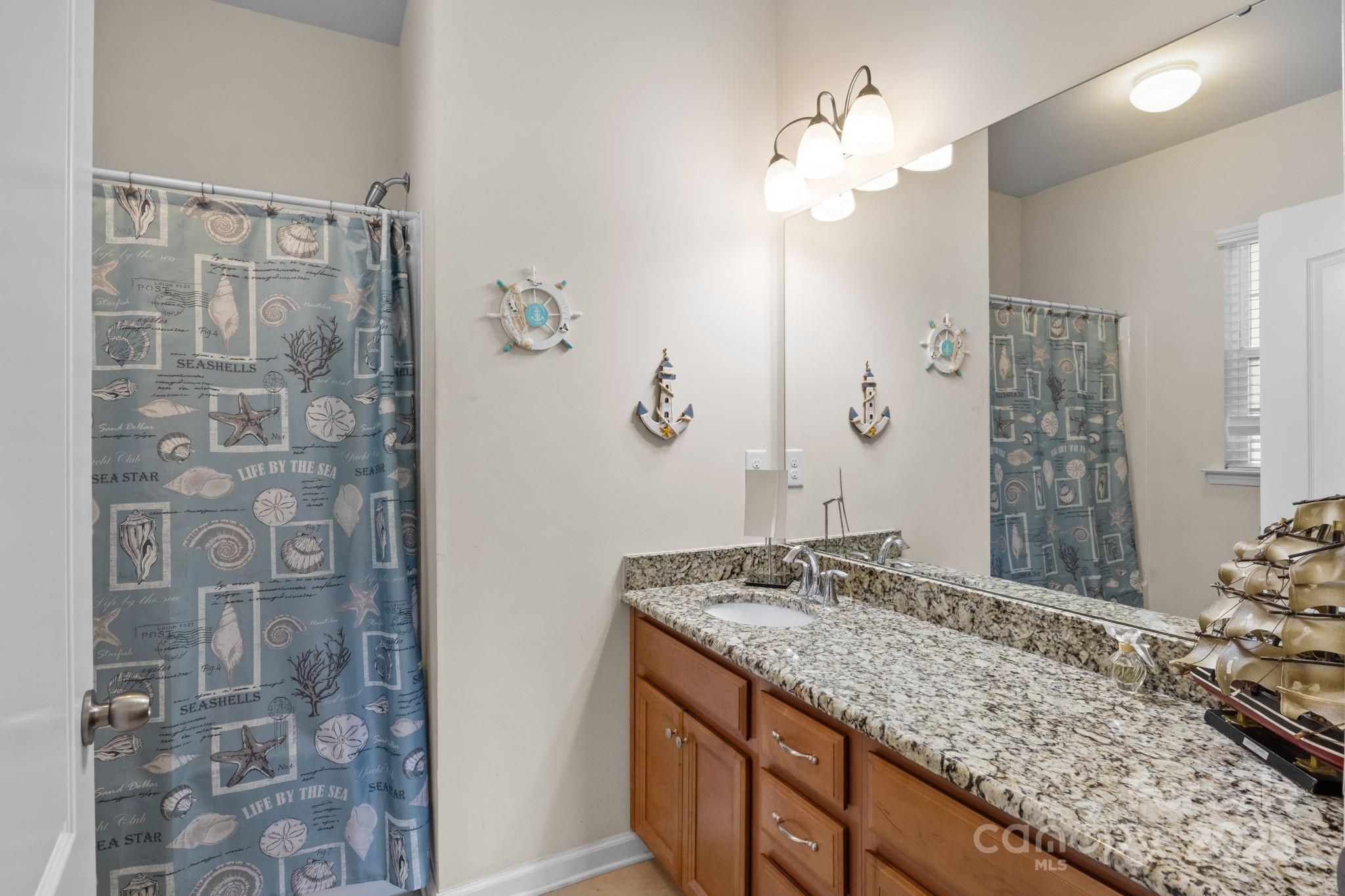 15925 Foreleigh Road Huntersville, NC 28078 - Photo 26 of 48 a bathroom with a granite countertop sink a mirror and shower