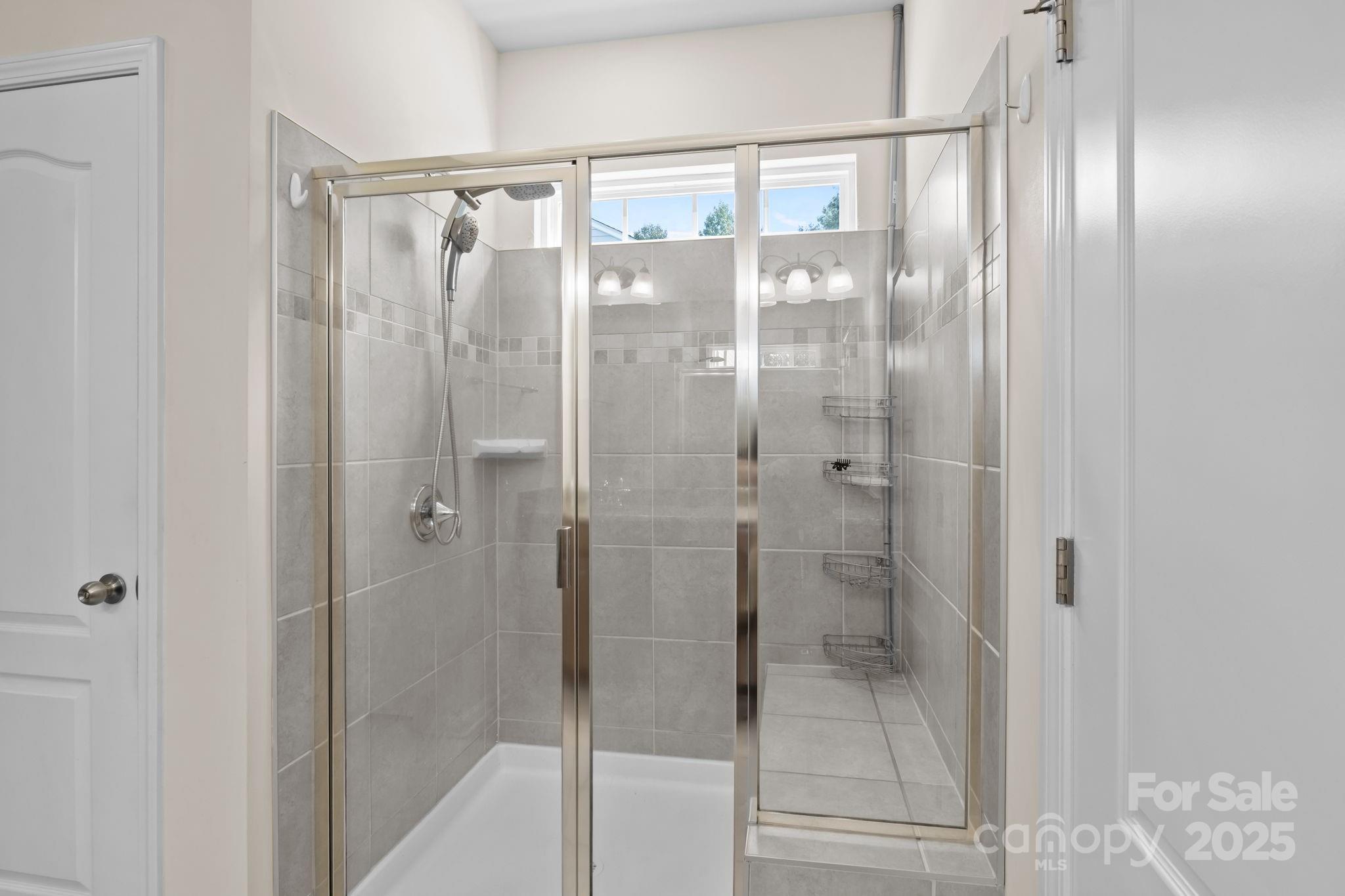 15925 Foreleigh Road Huntersville, NC 28078 - Photo 27 of 48 a bathroom with a glass shower door