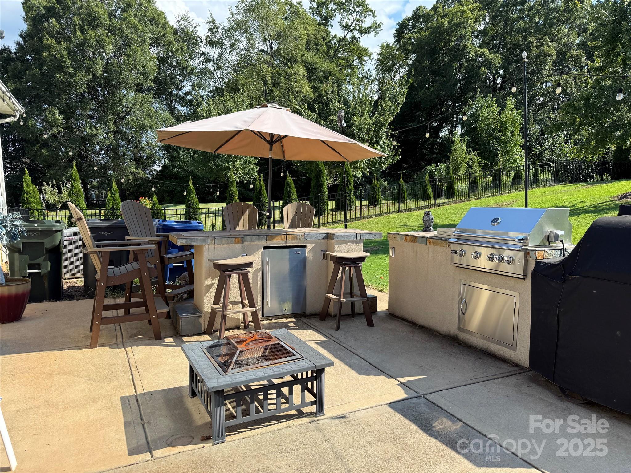 15925 Foreleigh Road Huntersville, NC 28078 - Photo 3 of 48 a view of a patio with table and chairs under an umbrella