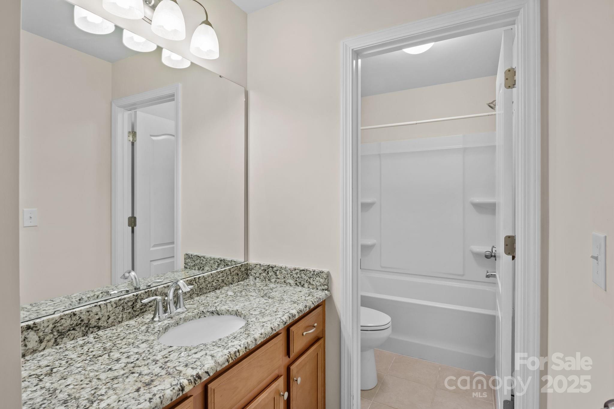 15925 Foreleigh Road Huntersville, NC 28078 - Photo 31 of 48 a bathroom with a granite countertop sink toilet and shower