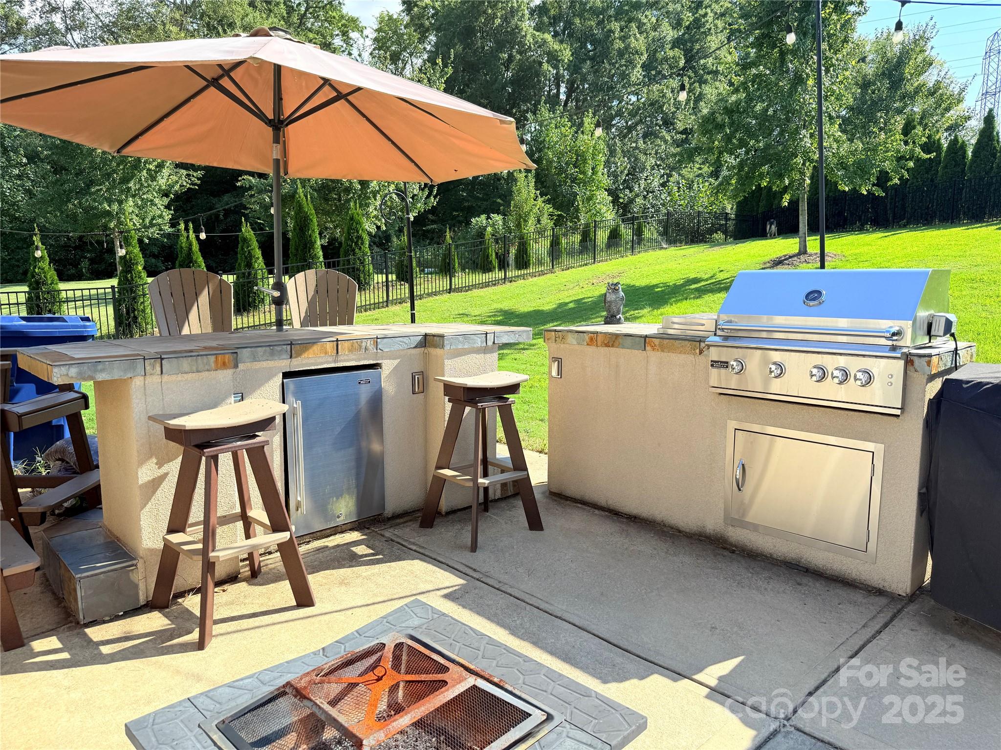 15925 Foreleigh Road Huntersville, NC 28078 - Photo 4 of 48 a patio with a table and chairs under an umbrella
