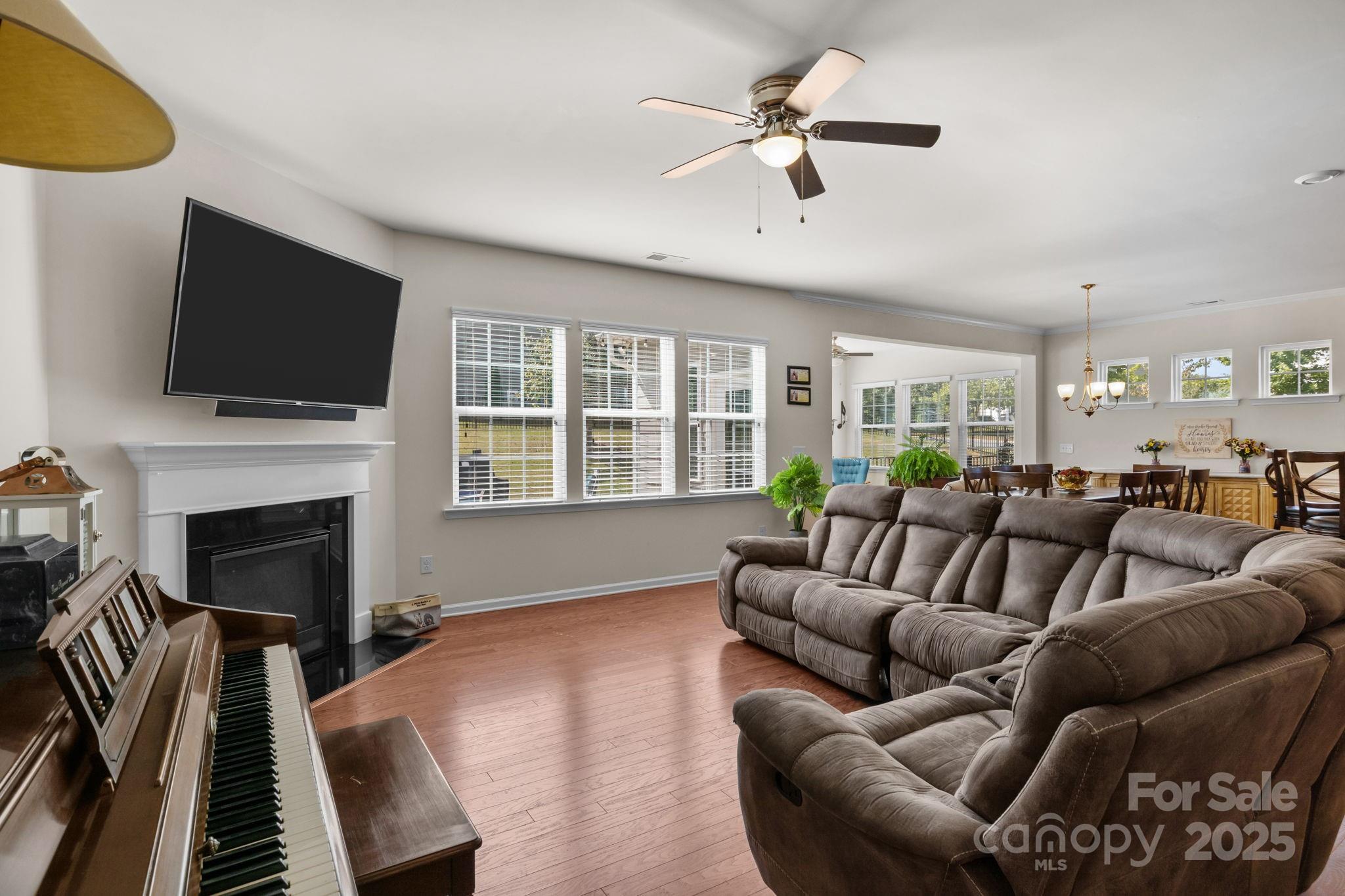15925 Foreleigh Road Huntersville, NC 28078 - Photo 7 of 48 a living room with furniture a fireplace and a flat screen tv