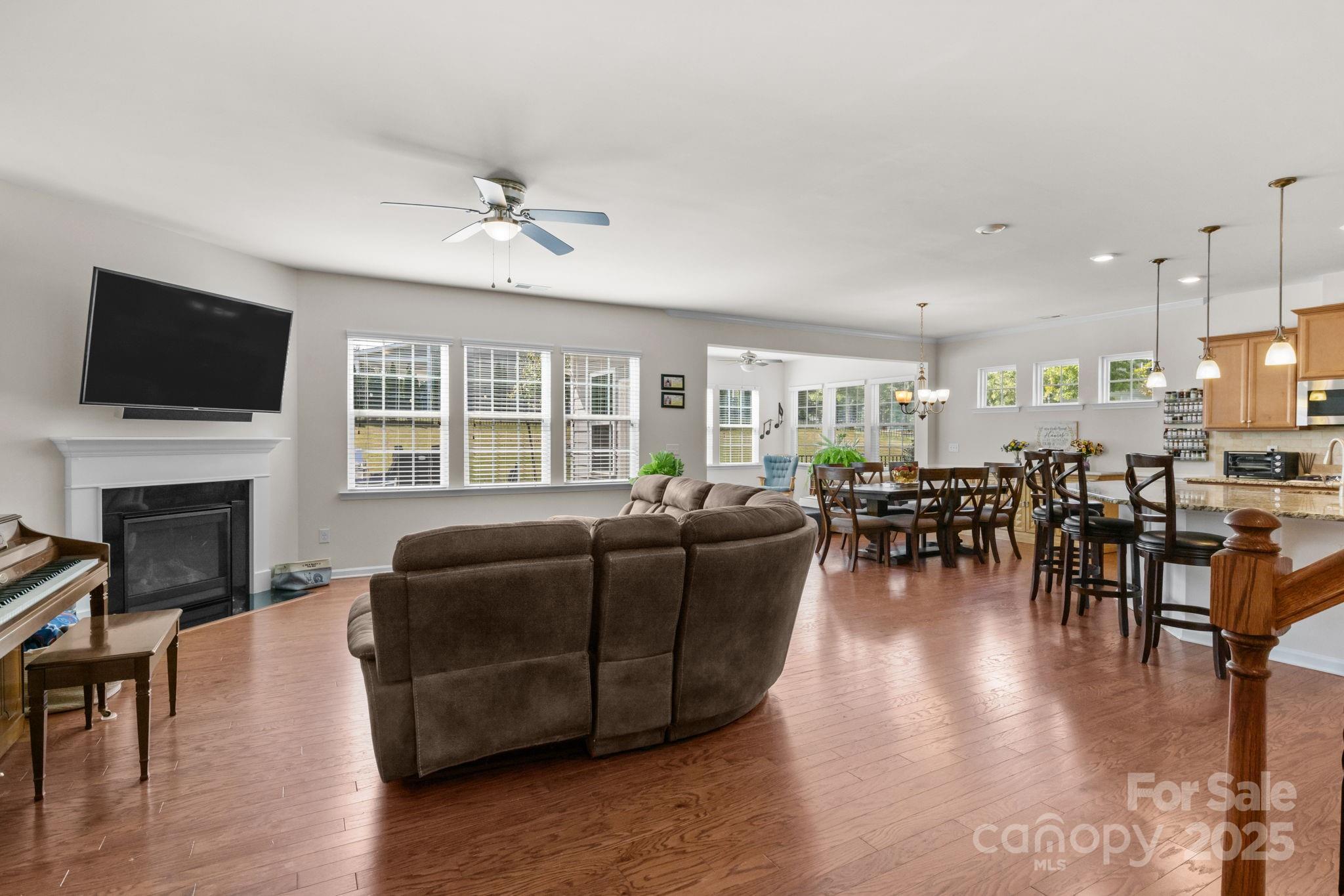 15925 Foreleigh Road Huntersville, NC 28078 - Photo 8 of 48 a living room with furniture a fireplace and a flat screen tv