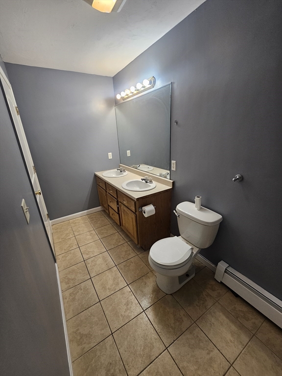 40 Merrick Street, Unit A Worcester, MA 01609 - Photo 21 of 32 a bathroom with a toilet a sink and mirror