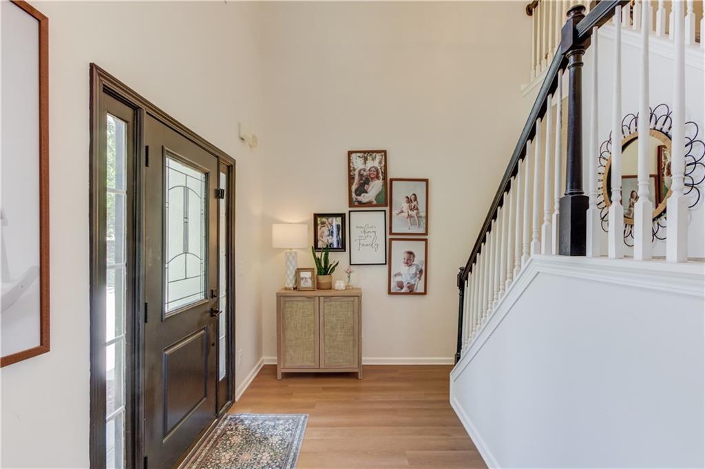 2310 Olde Hickory Place Monroe, GA 30656 - Photo 5 of 46 a view of a hallway with wooden floor and staircase
