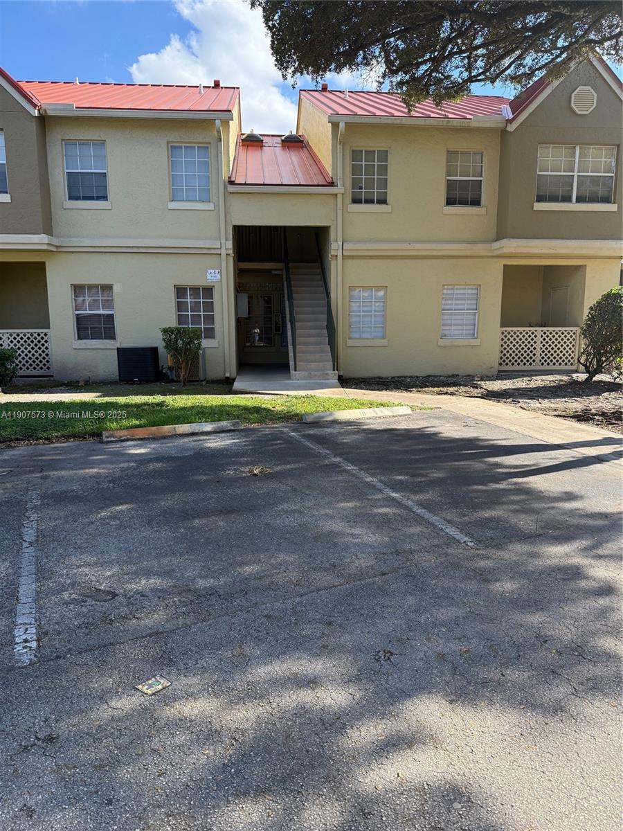 18308 Northwest 68th Avenue, Unit F Hialeah, FL 33015 - Photo 1 of 17 a house view with a outdoor space