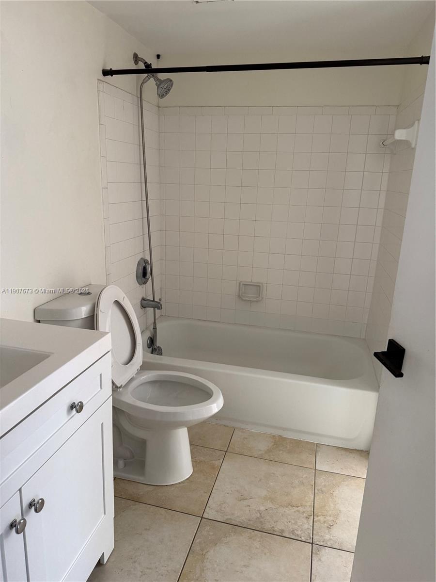 18308 Northwest 68th Avenue, Unit F Hialeah, FL 33015 - Photo 11 of 17 a bathroom with a sink a toilet and shower