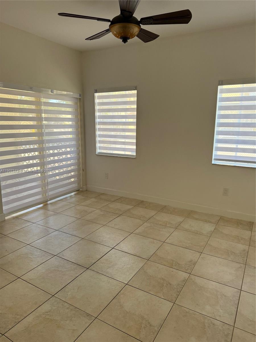 18308 Northwest 68th Avenue, Unit F Hialeah, FL 33015 - Photo 4 of 17 a view of an empty room with a window