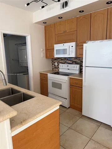 a kitchen with a sink a stove and refrigerator