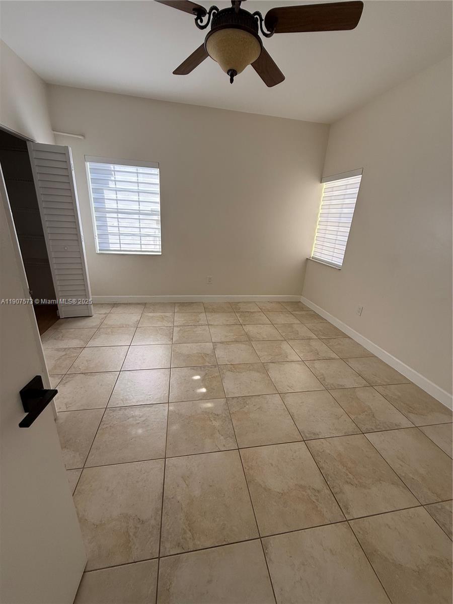 18308 Northwest 68th Avenue, Unit F Hialeah, FL 33015 - Photo 8 of 17 a view of an empty room with a window