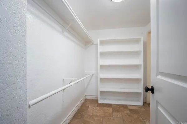 a bathroom with a granite countertop sink and a large mirror next to a window