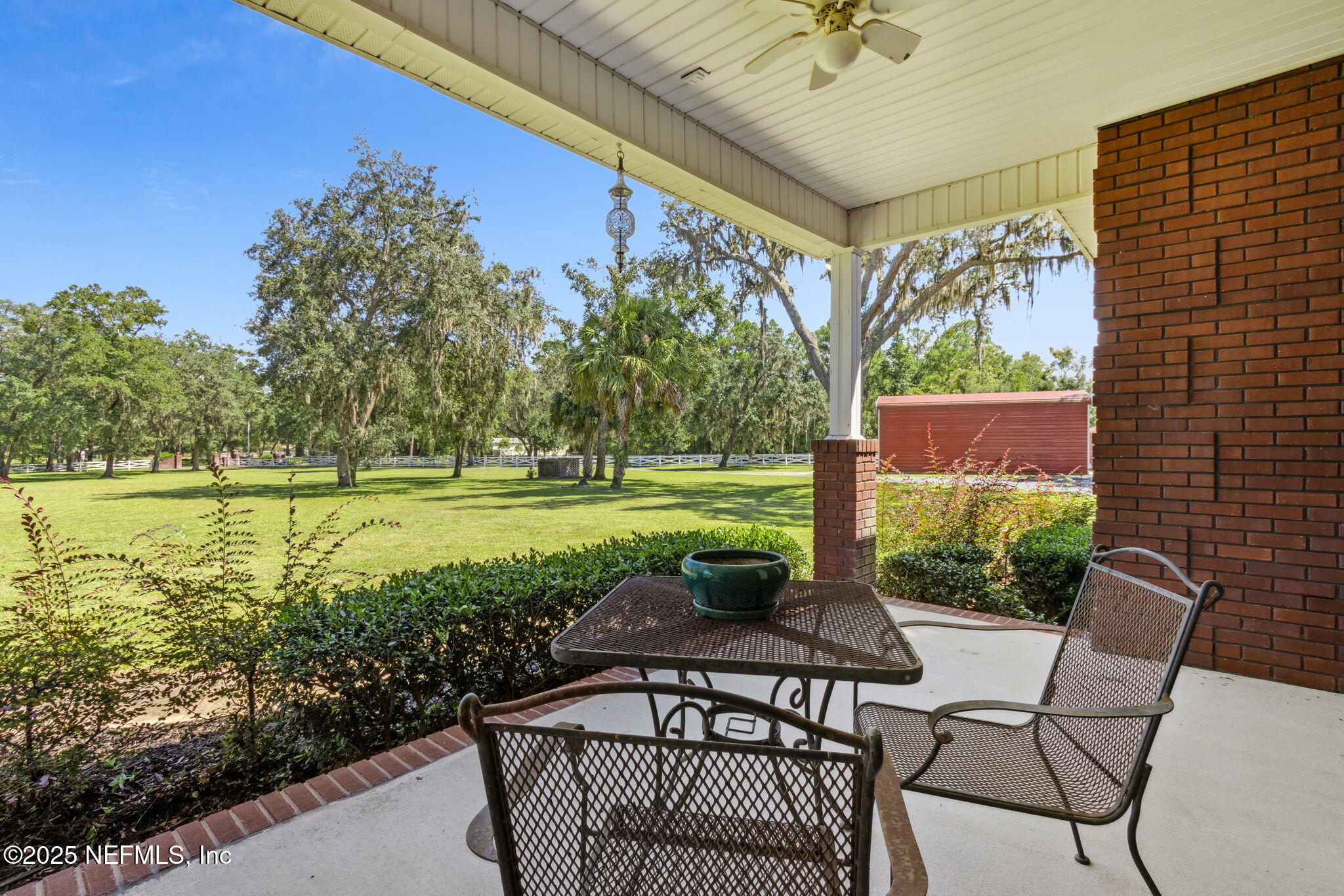 87377 Raddin Road Yulee, FL 32097 - Photo 11 of 75 a view of a patio with a table chairs and a table