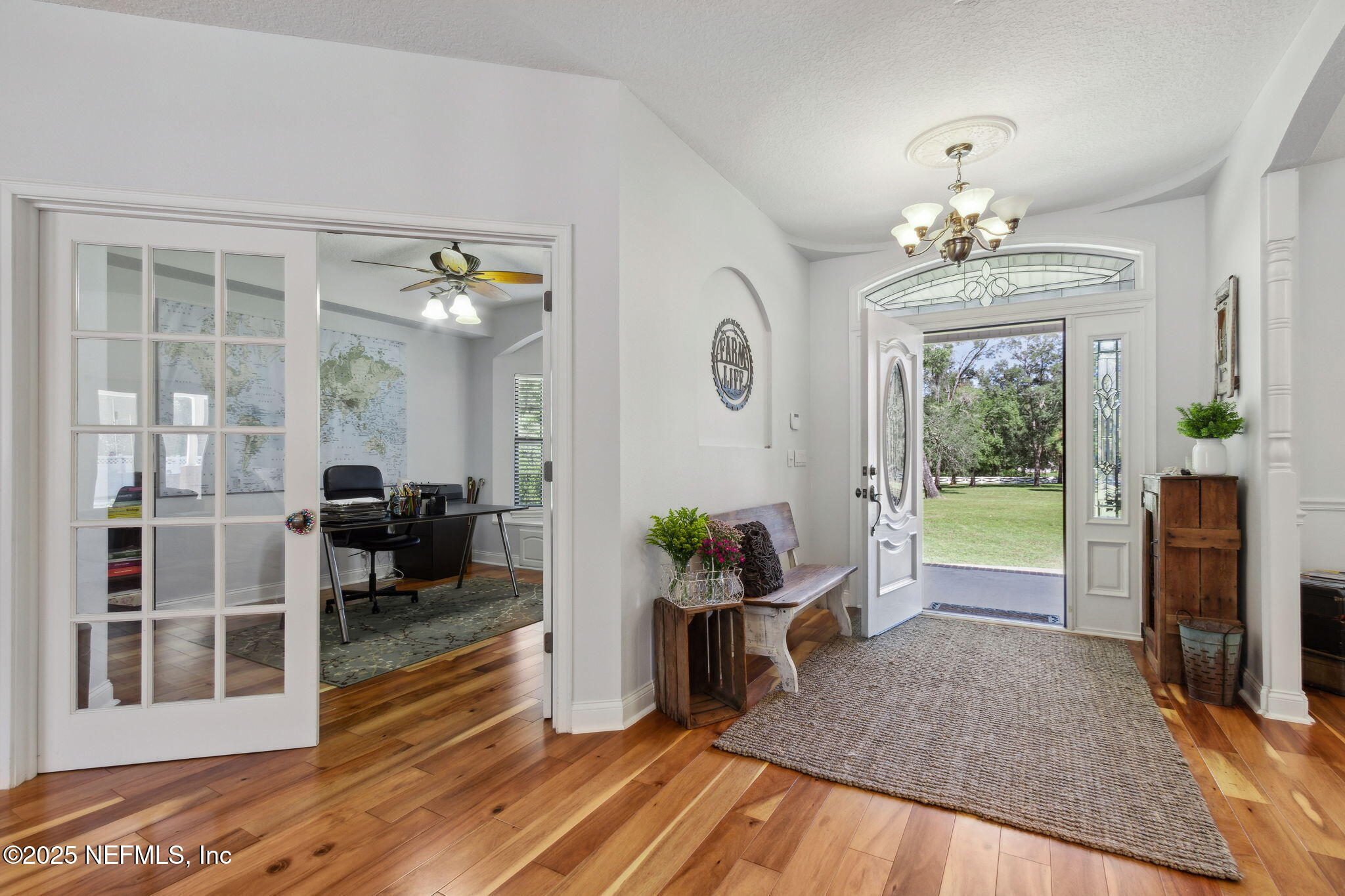 87377 Raddin Road Yulee, FL 32097 - Photo 15 of 75 a living room with furniture and a chandelier