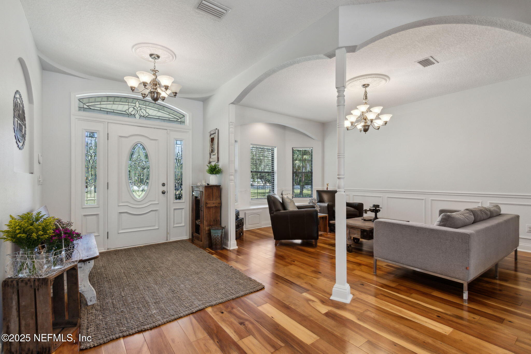 87377 Raddin Road Yulee, FL 32097 - Photo 16 of 75 a living room with furniture chandelier and a rug