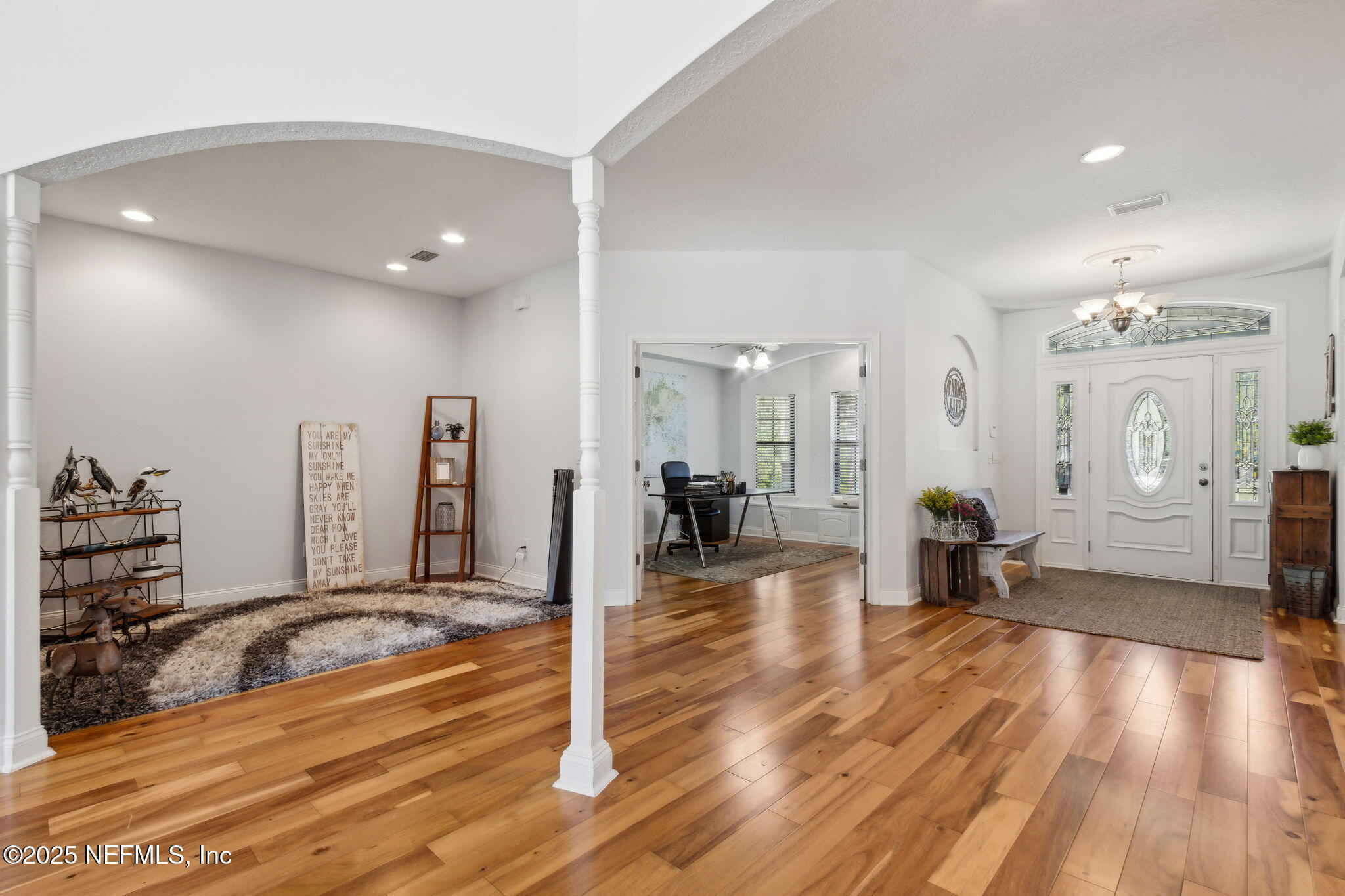 87377 Raddin Road Yulee, FL 32097 - Photo 17 of 75 a view of a living room and a hall with wooden floor